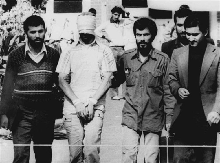 FILE - In this Nov. 9, 1979 file photo, one of the hostages being held at the U.S. Embassy in Tehran is displayed blindfolded and with his hands bound to the crowd outside the embassy. Fifty-two of the hostages endured 444 days of captivity. On the 30th anniversary of their release, at least 10 former hostages have said they will join each other for a reunion hosted by the U.S. Military Academy at West Point on Jan. 20, 2011. (AP Photo, File)